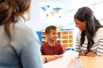 stock photo of SLP and interpreter with young student